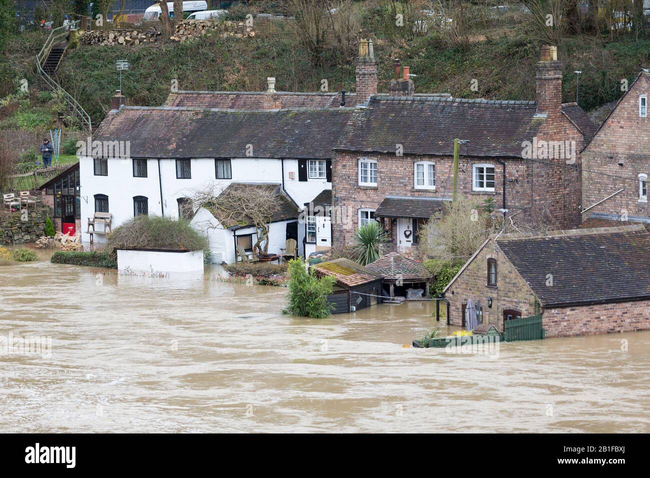 Ironbridge, Shropshire, UK. 25th Feb, 2020. Severe flood warning in place on the River Severn at Ironbridge, Shropshire. A house on the riverside is in danger of flooding as river levels continue to rise. Credit: Peter Lopeman/Alamy Live News Stock Photo