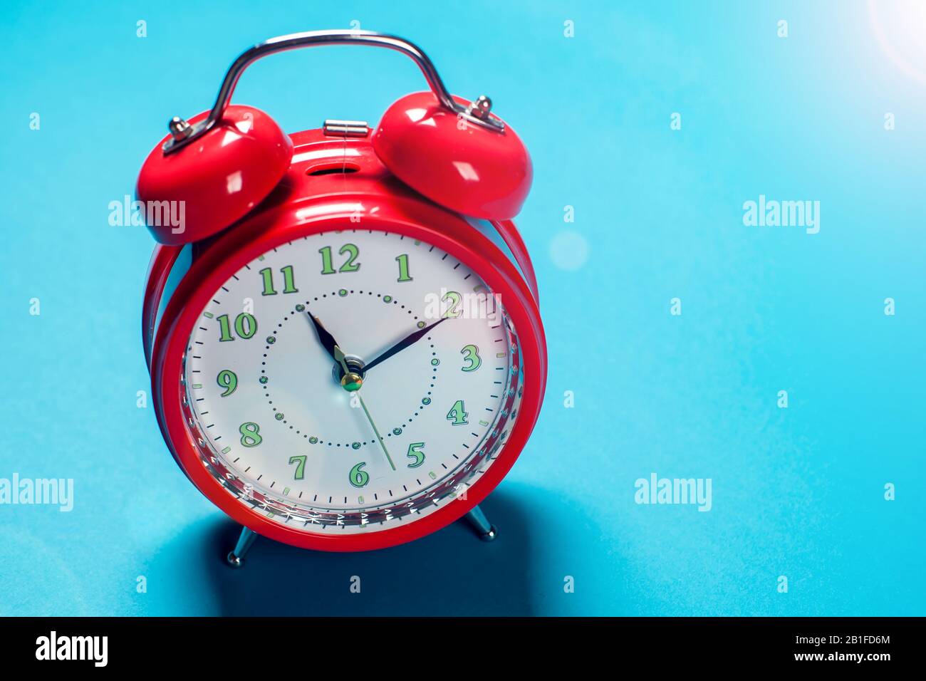 Red alarm clock on the color background. Stock Photo