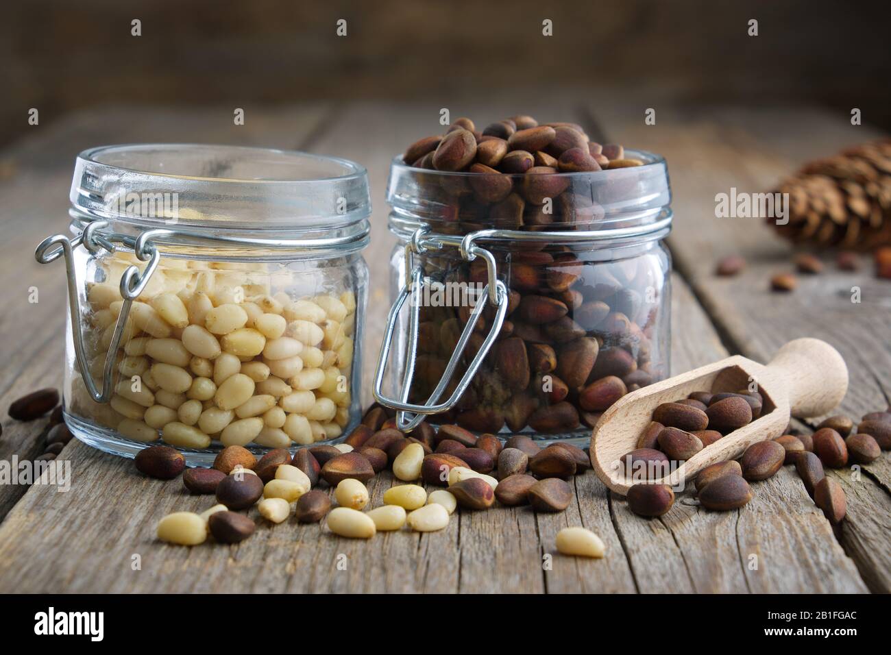 Pine nuts. Jars of cedar pine nuts on table. Stock Photo