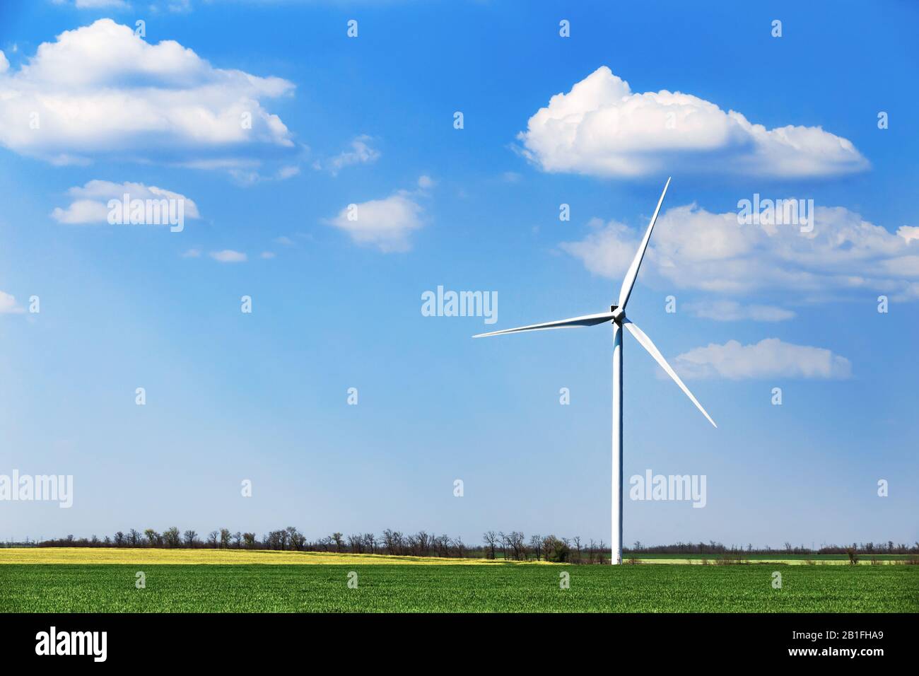 Wind turbine of blue sky with clouds background Stock Photo - Alamy