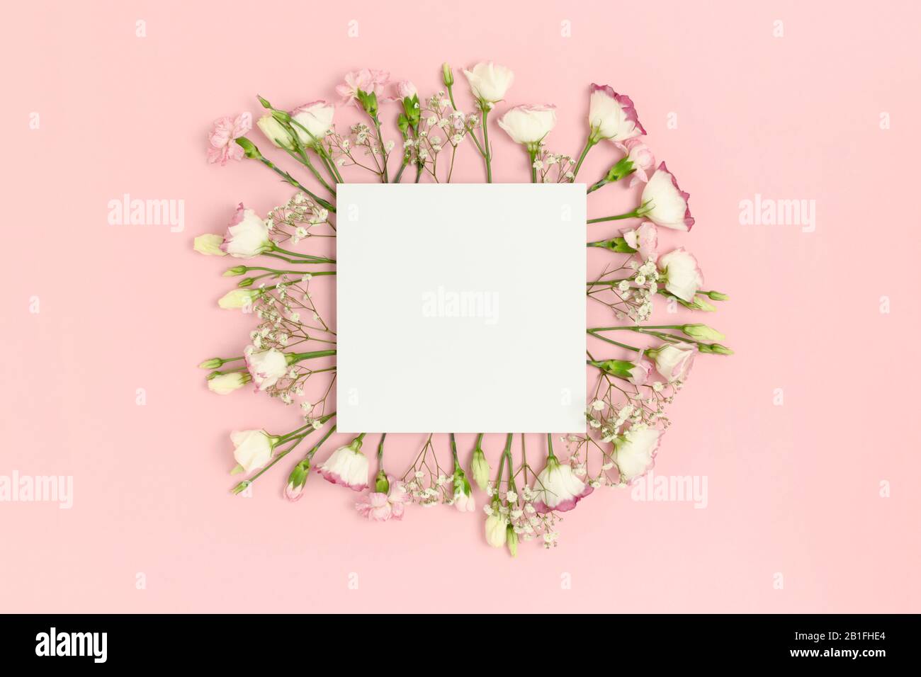 Blank paper card mockup with copy space. Frame made of flowers on a ...
