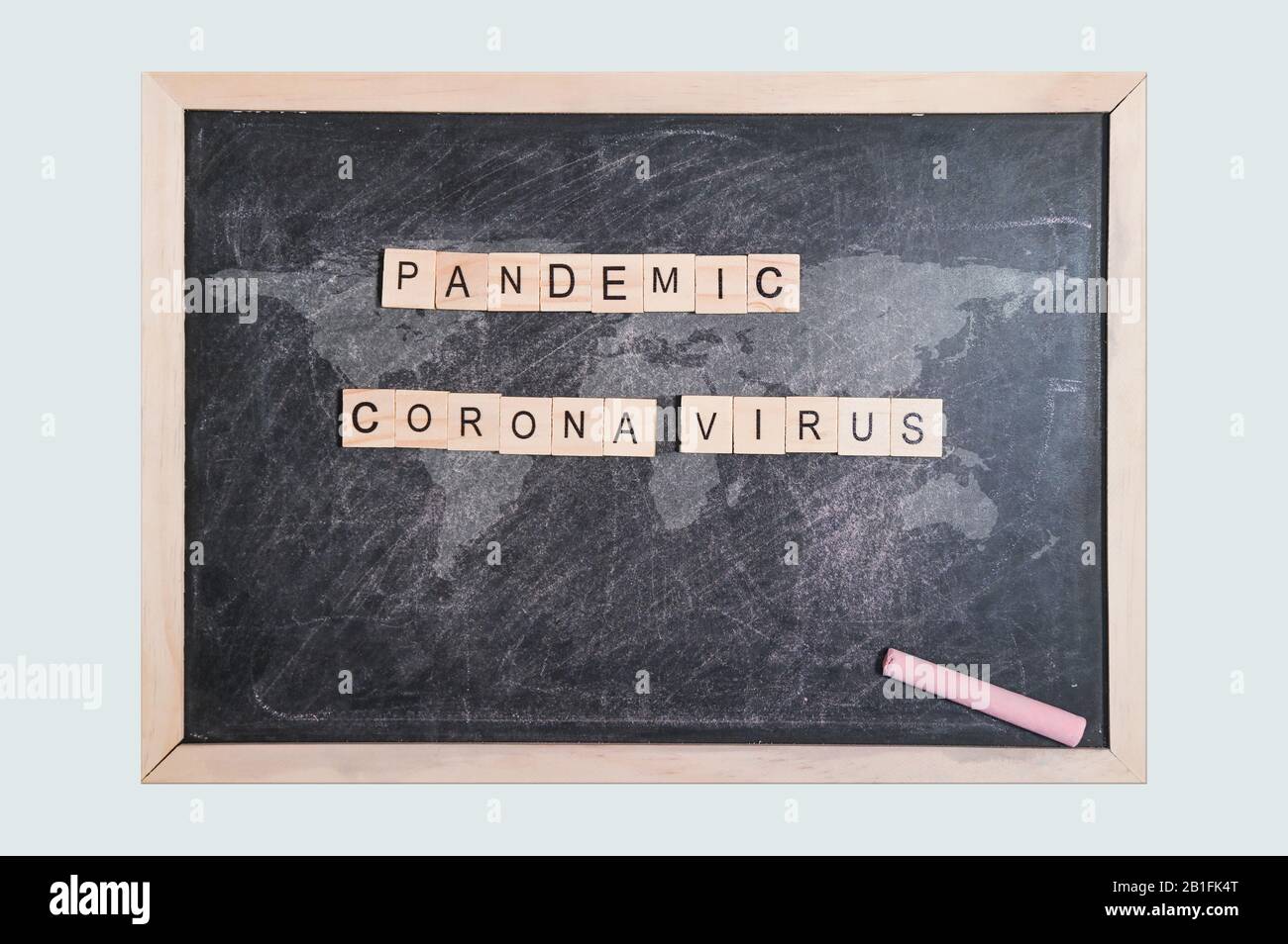 pandemic corona virus word written wood block. on black board with world map calk written for your desing, top view. Stock Photo