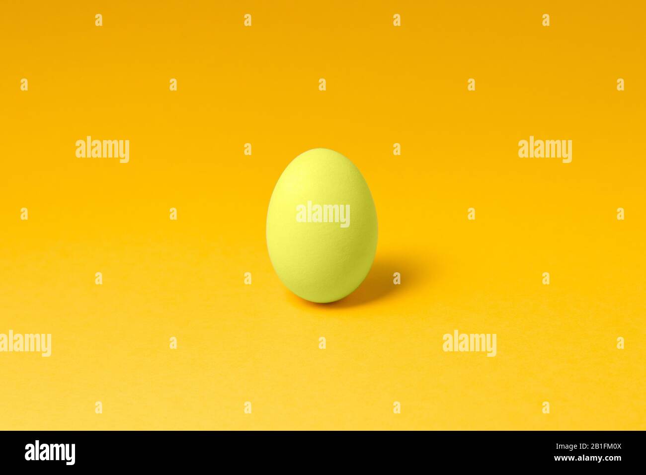 One Pastel Yellow Color Egg In Center On Yellow Background Easter Concept Design Stock Photo Alamy