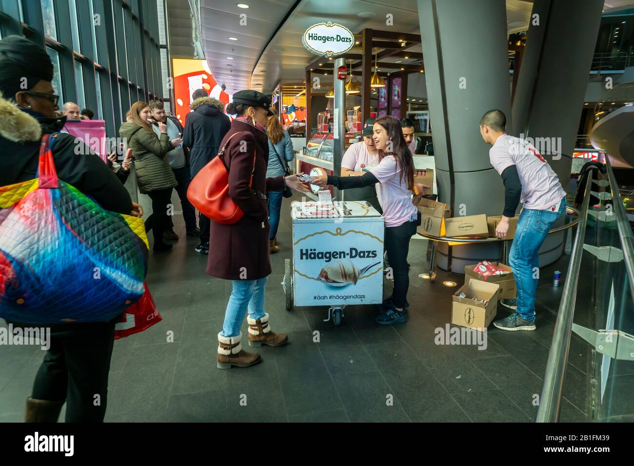 Workers for Häagen-Dazs distribute free Ruby Cacao ice cream bars during a brand activation at their store in the Fulton Center in New York on Friday, February 14, 2020. (© Richard B. Levine) Stock Photo