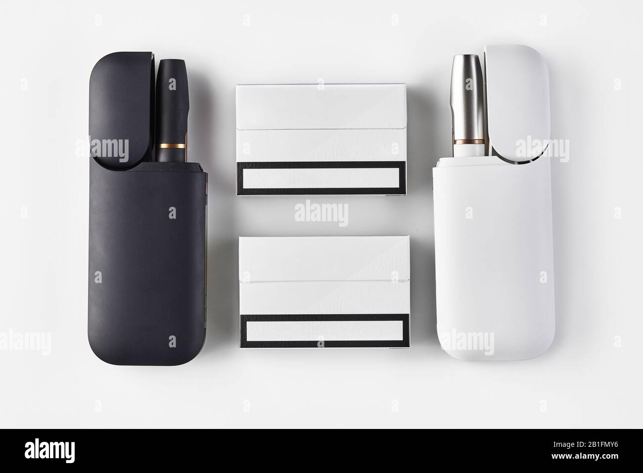 New generation black and white electronic cigarettes in open batteries and  two packs isolated on white. Hi-tech heating tobacco system. Tools used to  Stock Photo