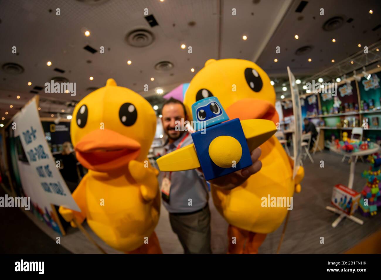 Jordan Willing, inventor of Blockaroos poses with “out of work” rubber duckies at the 117th North American International Toy Fair in the Jacob Javits Convention center in New York on Sunday, February 23, 2020. The ducks were protesting their replacement in baths by the Blockaroo toys..  The toy industry generates over $26 billion in the U.S. alone and Toy Fair is the largest toy trade show in the Western Hemisphere. (© Richard B. Levine) Stock Photo