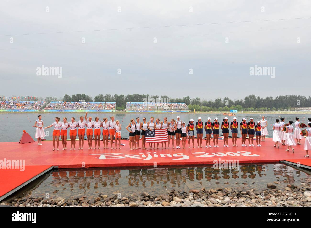 Shunyi, CHINA. Medal Presentation.  Women's Eights. left to right, NED W8+ silver medalist, Centre USA W8+ Gold Medalist and Bronze medalist ROM W8+2008 Olympic Regatta, Shunyi Rowing Course.  Sun 17.08.2008.  [Mandatory Credit: Peter SPURRIER, Intersport Images.  centre; Gold medalist CHN W4X left to right  Bin Tang, Jin Ziwei, Aihua Xi, Yangyang Zhang)  Left; Silver medalist GBR W4X Annie VERNON, Debbie FLOOD, Frances HOUGHTON and Katerine GRAINGER  right;  Bronze  medalist  GER W4X left to right Britta Oppelt, Manuela Lutze, Kathrin Boron, Stephanie Schiller) Stock Photo