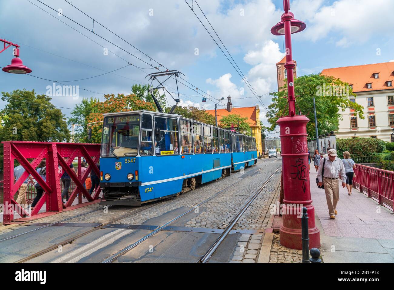 Wroclaw, Poland - August 16, 2019: Public transportation tram transporting tourists over the Sand Bridge (Most Piaskowy) to the historic center Stock Photo