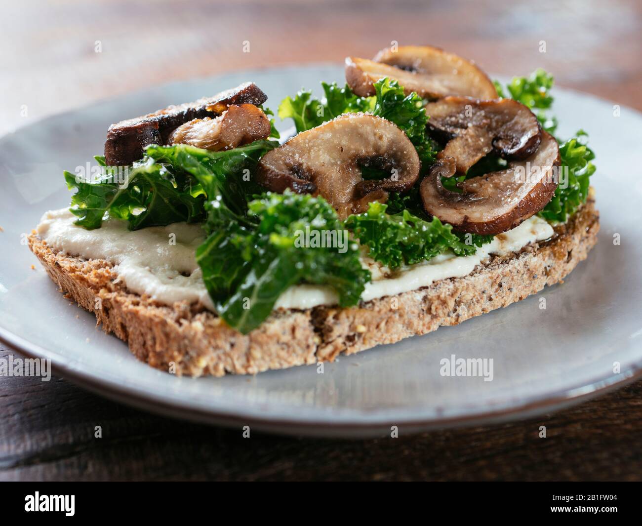 Mushrooms and Kale with Vegan Ricotta on Toast Stock Photo