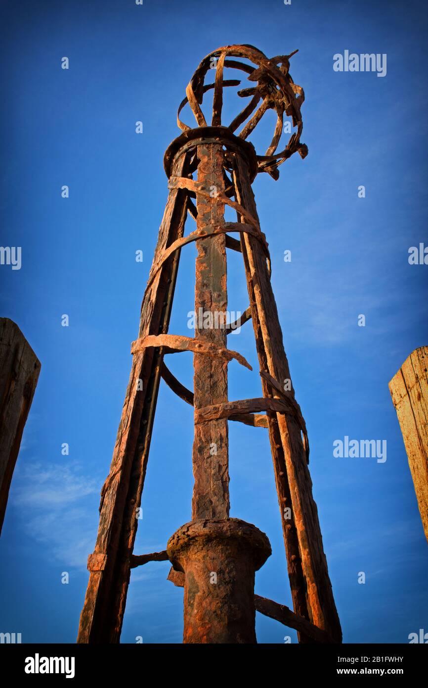 A rusting beacon, leaning and broken, on the old pier at Lytham St Annes, Lancashire, England, UK Stock Photo