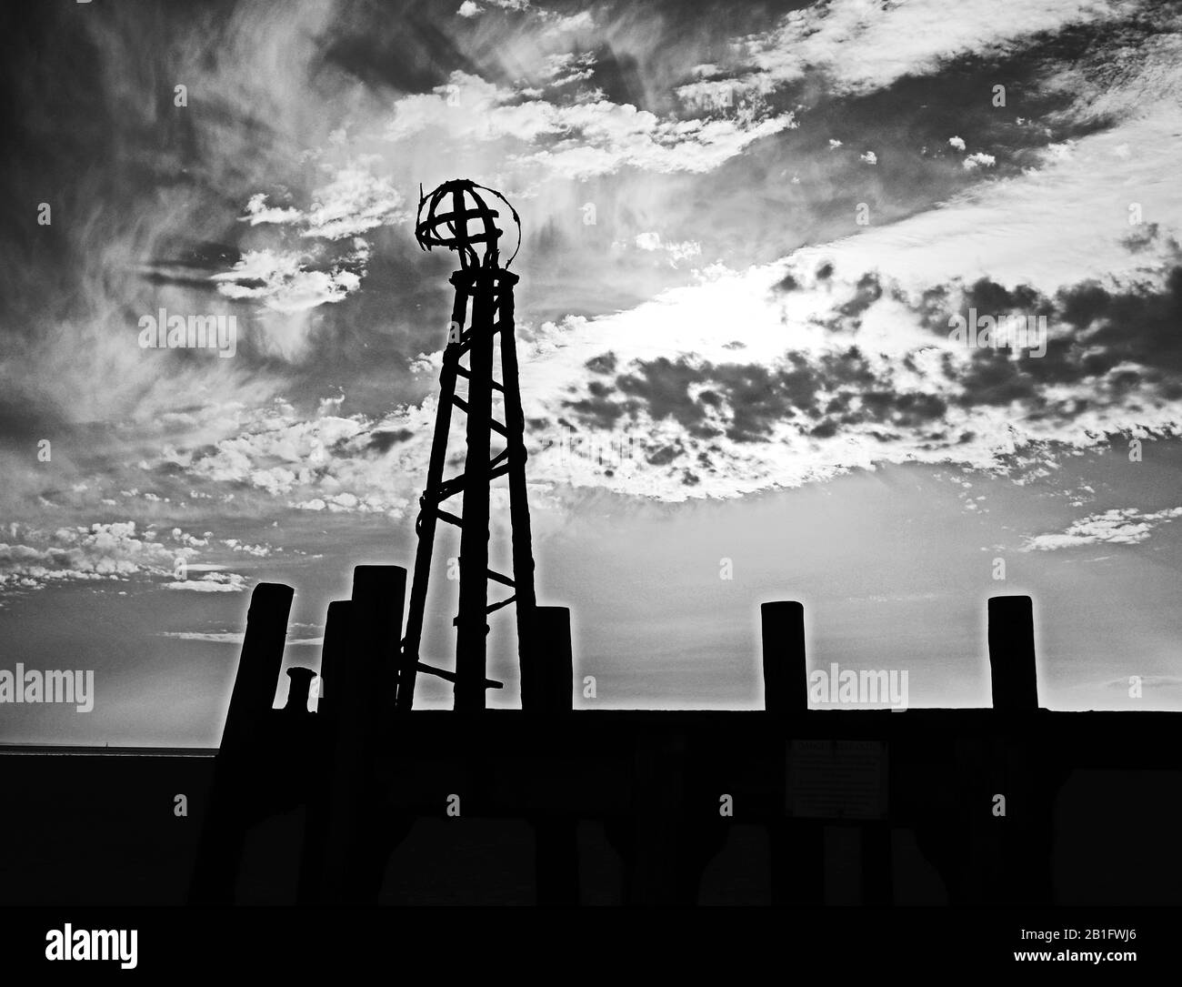 The old pier, silhouetted against a dramatic sky,  at Lytham St Annes, Lancashire, England, UK Stock Photo