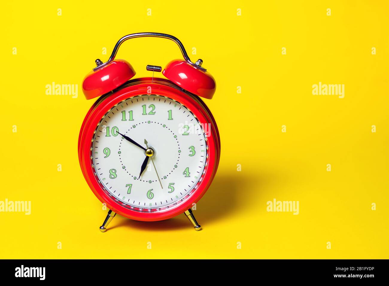 Red alarm clock is on color background. Time concept Stock Photo - Alamy