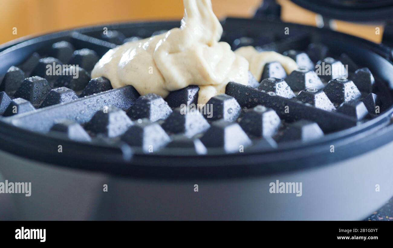 Making homemade waffles in an electric waffle maker Stock Photo Alamy