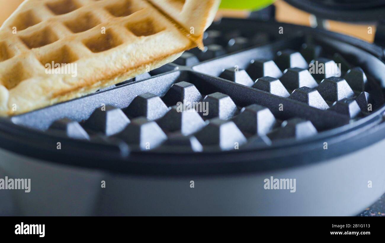 Making homemade waffles in an electric waffle maker Stock Photo Alamy