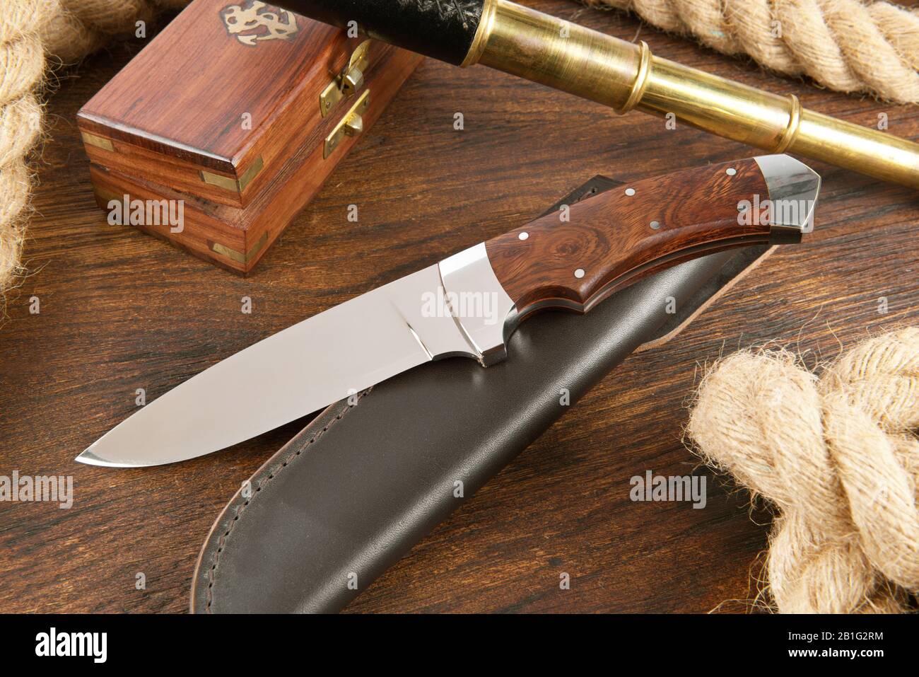 Knife with Rope on wooden Background Stock Photo Alamy