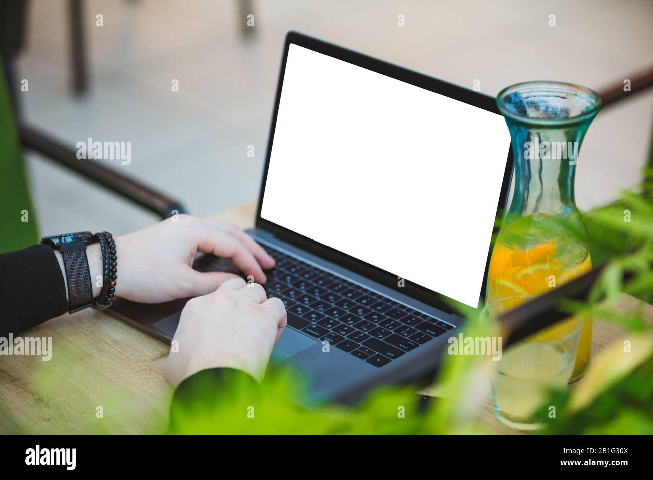 man working on laptop in cafe white screen Stock Photo