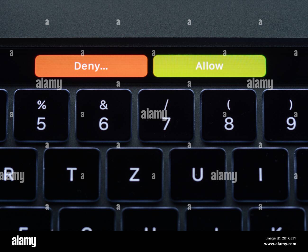 Choice between deny and allow on a laptop touch bar. Stock Photo