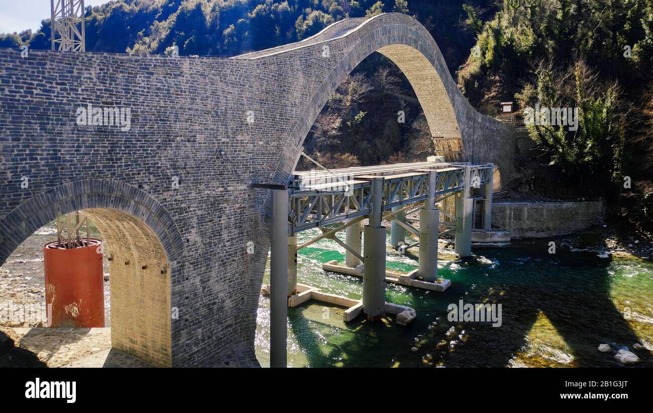 Ioannina Greece NEW re-builded Stone Bridge of Plaka in arachthos River tzoumerka, connects ioannina and Arta City, old one had collapsed on 2015 Stock Photo