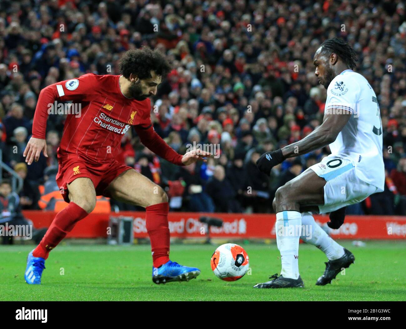 Anfield, Liverpool, Merseyside, UK. 24th Feb, 2020. English Premier League Football, Liverpool versus West Ham United; Mohammed Salah of Liverpool takes on Michail Antonio of West Ham United - Strictly Editorial Use Only. No use with unauthorized audio, video, data, fixture lists, club/league logos or 'live' services. Online in-match use limited to 120 images, no video emulation. No use in betting, games or single club/league/player publications Credit: Action Plus Sports/Alamy Live News Stock Photo