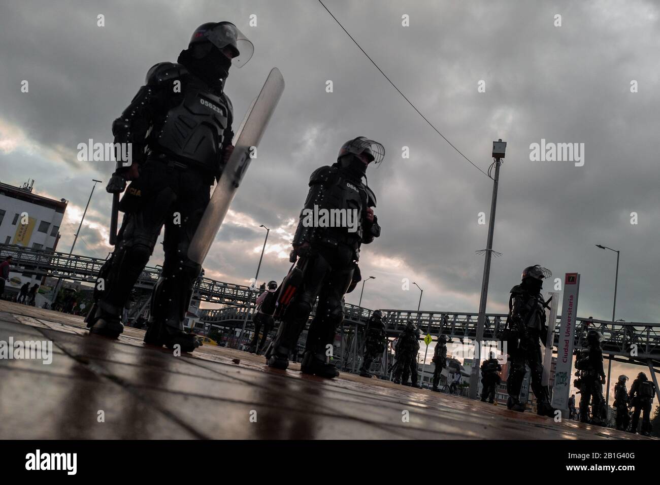 Colombian riot control policemen guard during a protest march against government’s policies in Bogotá, Colombia. Stock Photo