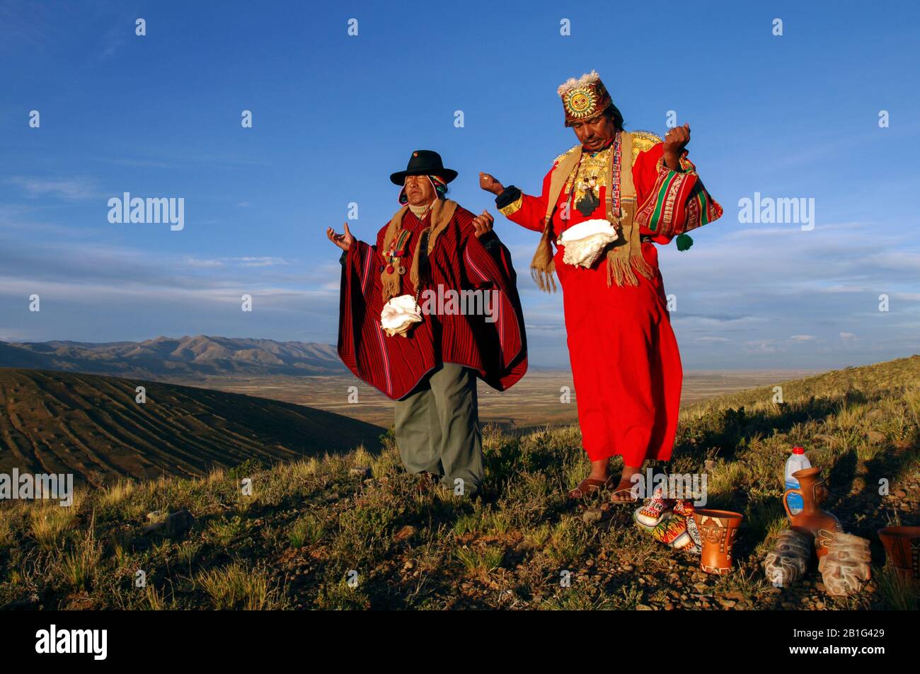 Two amautas, Aymara priests, make an offering to Pachamama, Mother Earth, to wish Evo Morales blessings during his term as president of Bolivia. Stock Photo