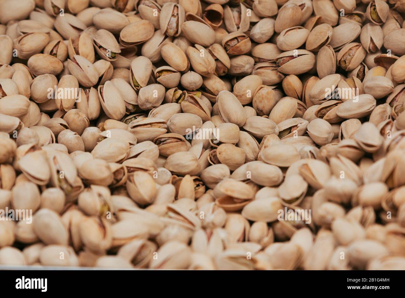 Stock photo of a close shot of a pile of delicious pistachios in a market stand creating a texture Stock Photo