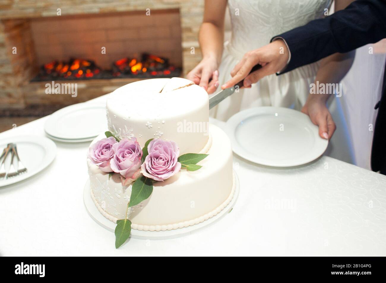 Young bride cutting wedding cake hi-res stock photography and images ...