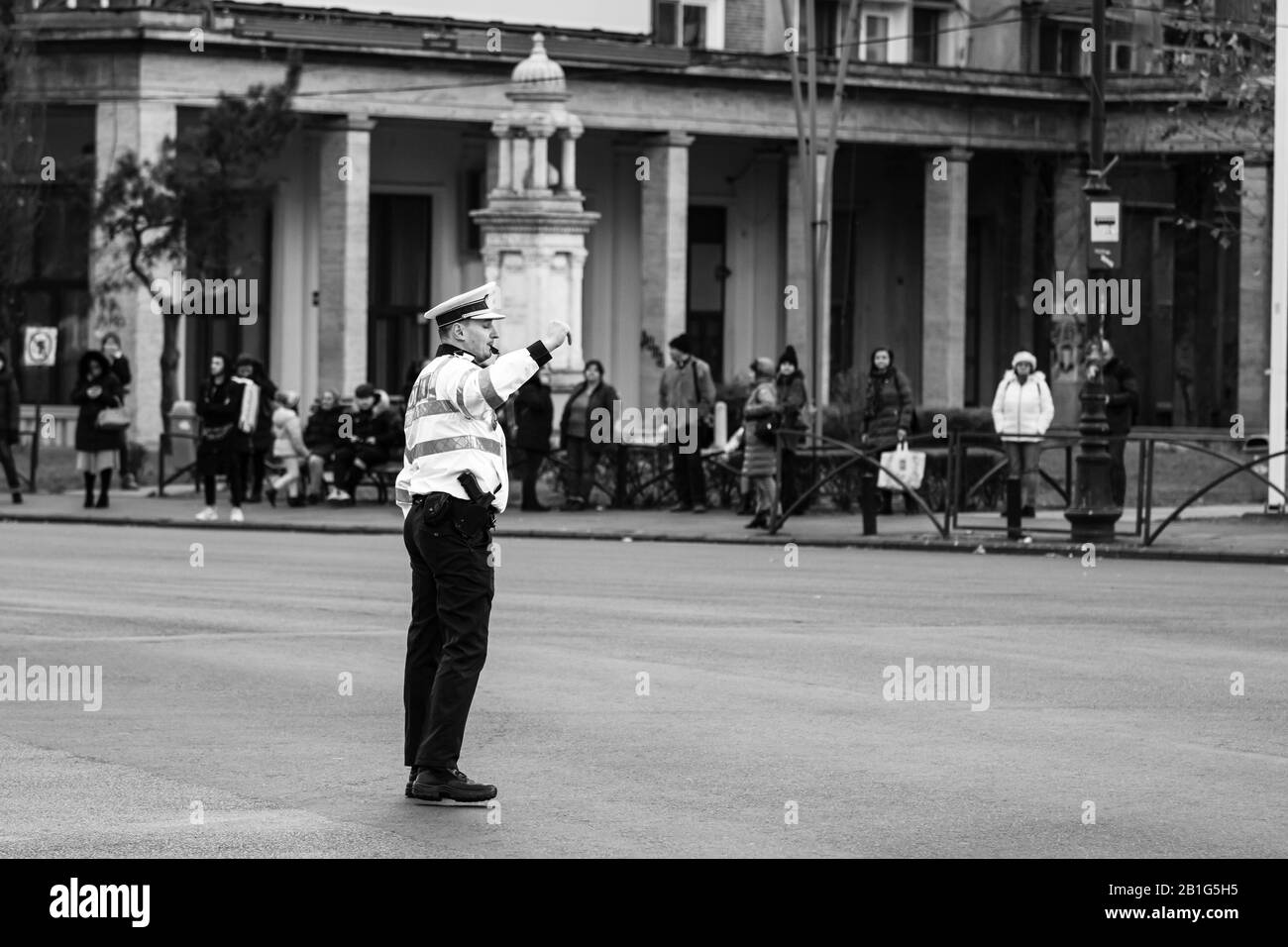 Police agent, Romanian Traffic Police (Politia Rutiera) directing traffic during the morning rush hour in downtown Bucharest, Romania, 2020 Stock Photo