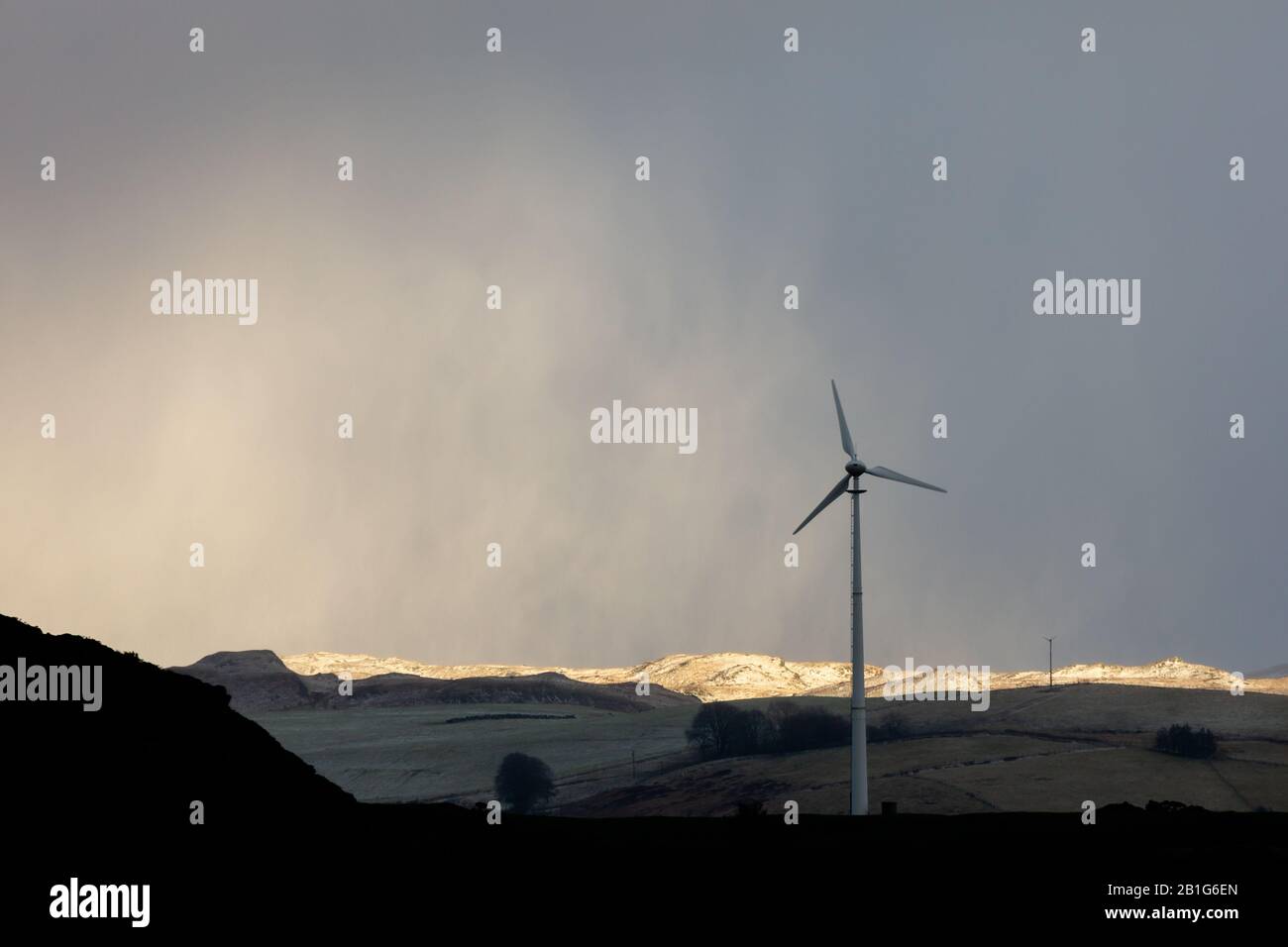 Near Tynygraig, Ceredigion, Wales, UK. 25th February 2020  UK Weather: A cold, breezy afternoon near Tynygraig in Ceredigion, as a small band of light breaks through the cloud, highlighting the snow forming on the Cambrian Mountains in Mid Wales this afternoon. © Ian Jones/Alamy Live News Stock Photo