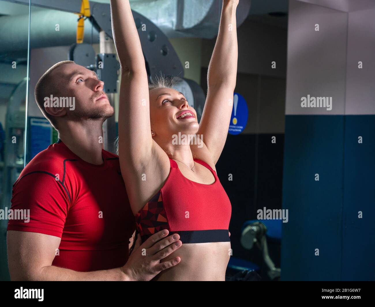 personal trainer man working with young woman in modern gym Stock Photo ...