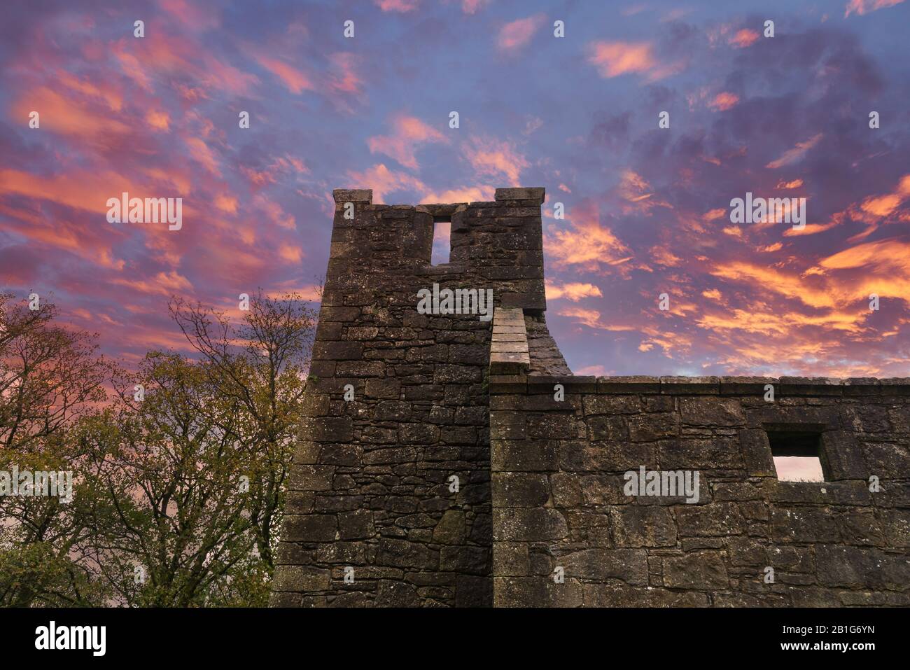 Looking up the tower of The Old Semple Ruins at Castle Semple in Renfrewshire Scotland at a Blazing Red sunset Stock Photo