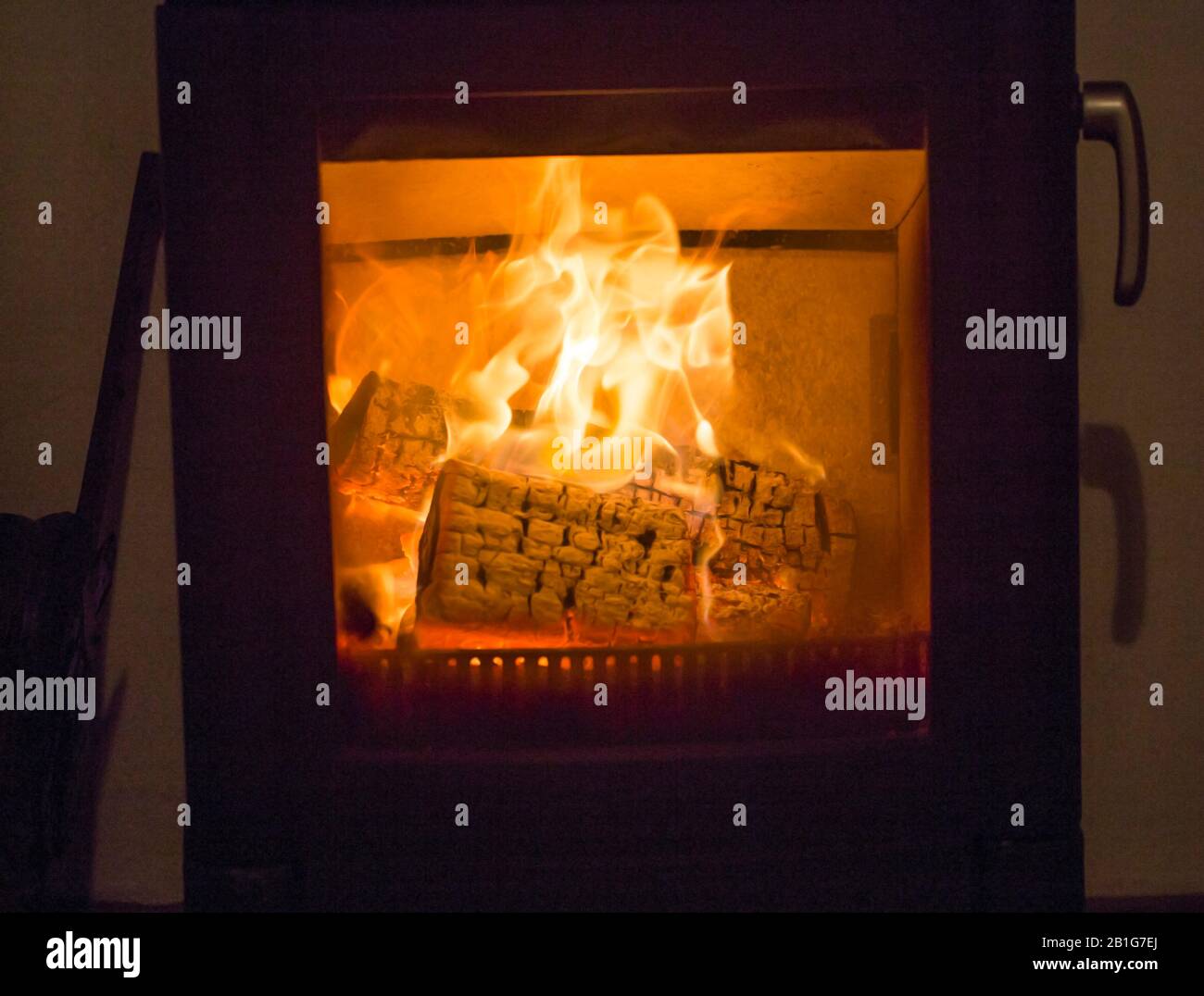 Logs burning in a wood burning stove Stock Photo Alamy