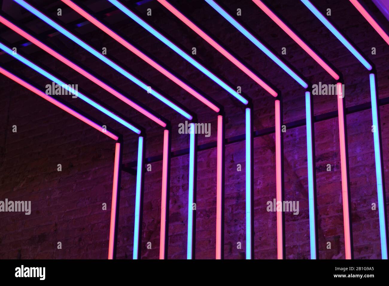 Neon red and blue lights stone wall background Stock Photo