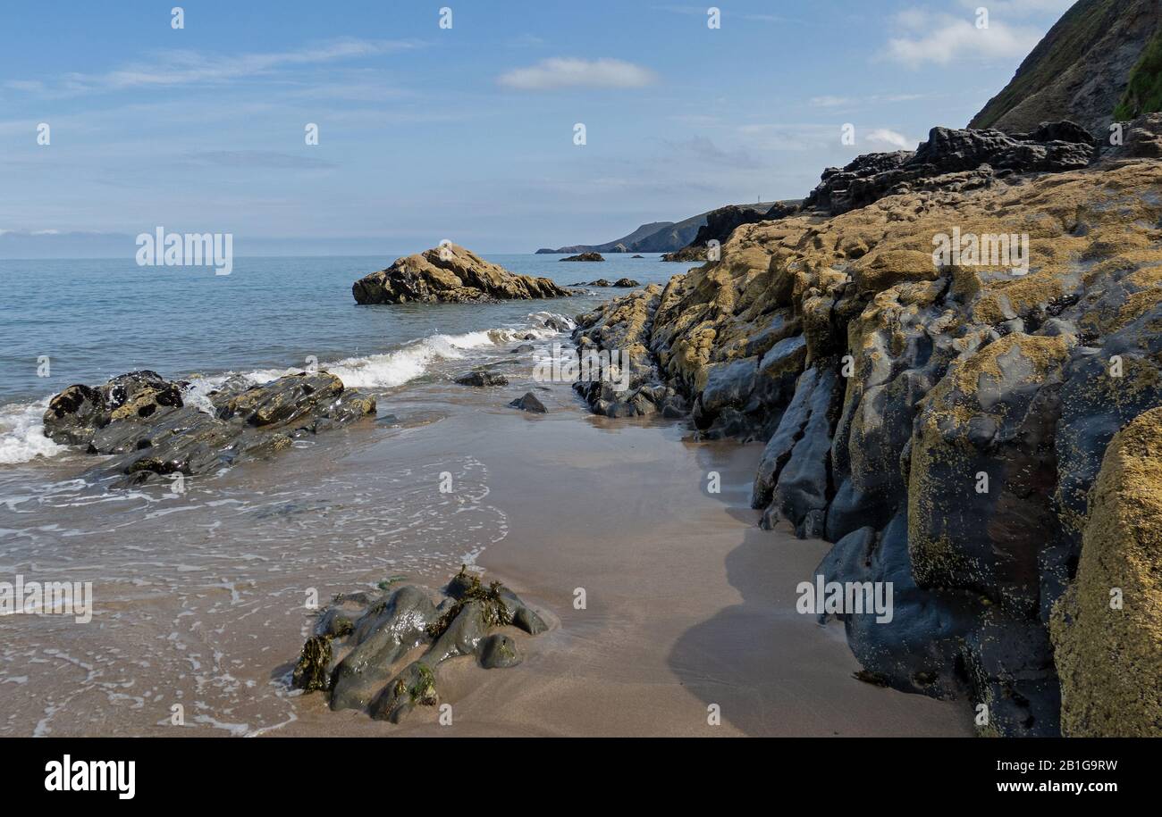 Colour photograph landscape of barnacle covered coastal rock the image is a part of the beach at Tresaith in Cardigan Bay West Wales Stock Photo