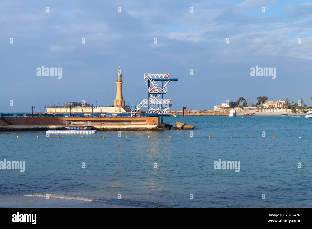 Montazah beach. Coastal landscape with lighthouse and diving tower on a breakwater. Alexandria