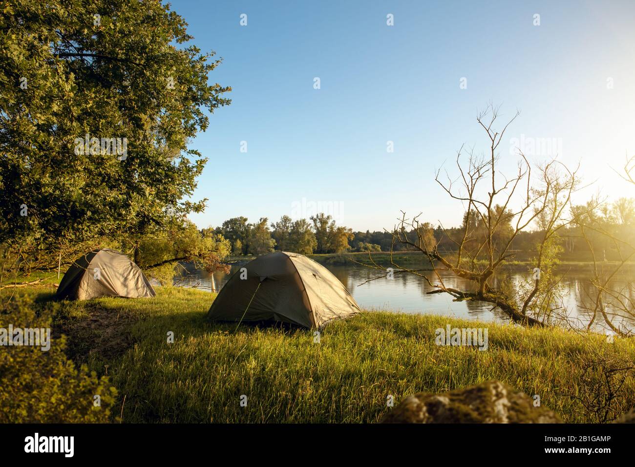 Two tents next to a river in the morning Stock Photo - Alamy