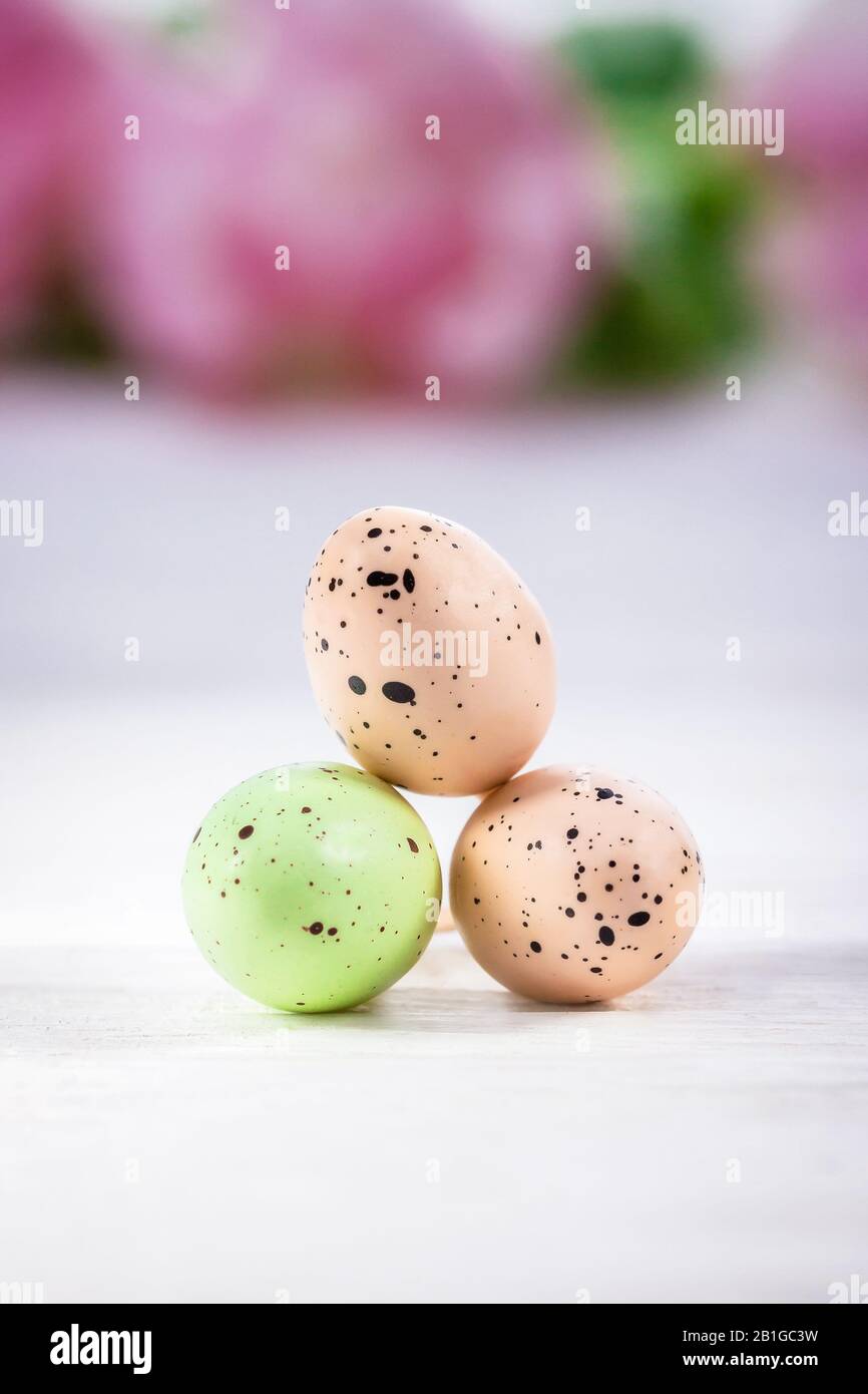 Happy Easter. Three pastel Easter eggs on a white background, copy space Stock Photo