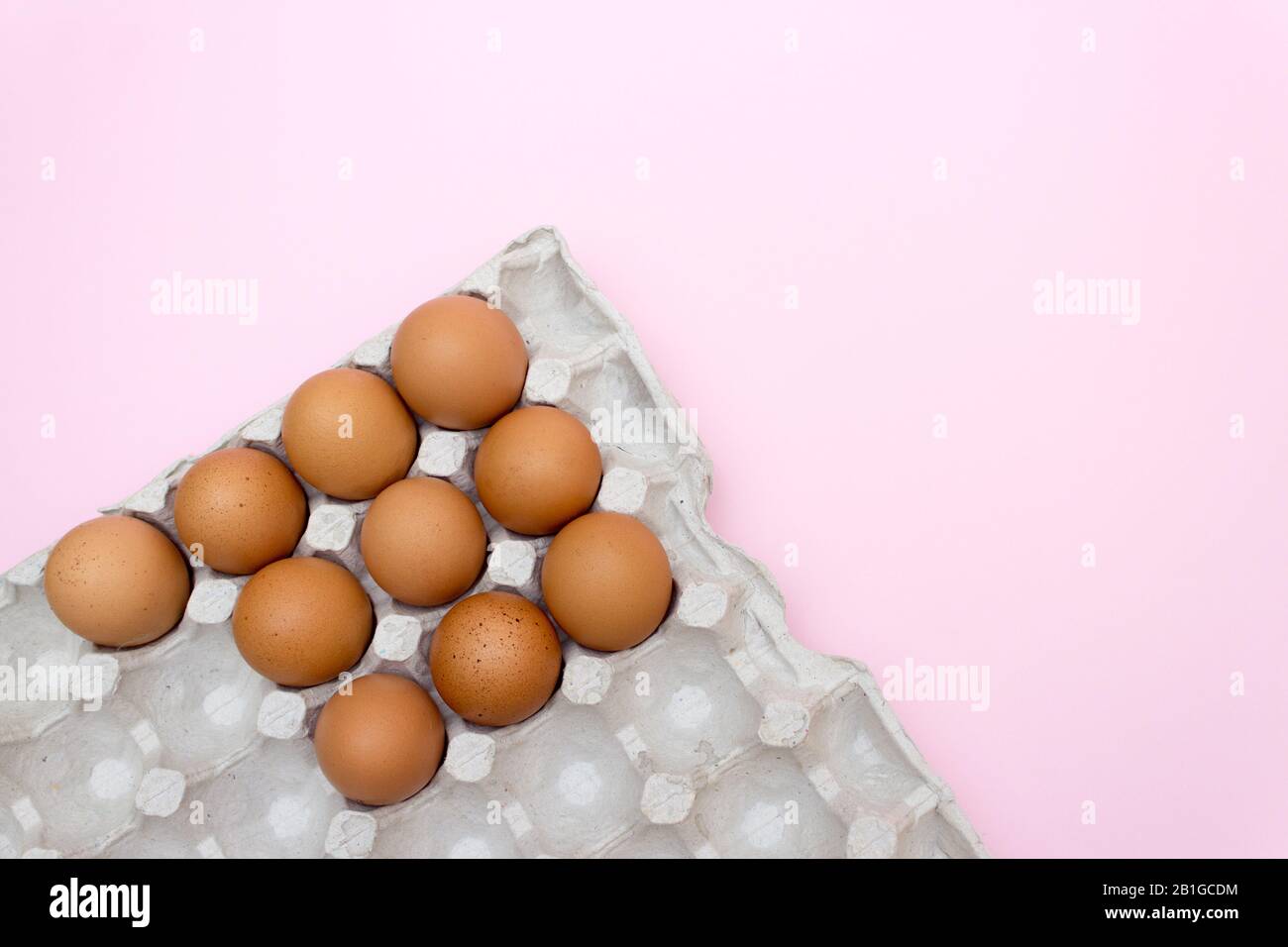 Egg, Eggs on a pink background. Eggs in a tray Stock Photo