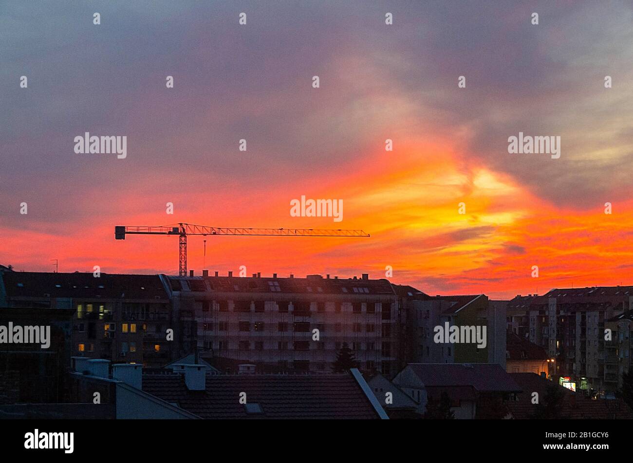 Construction site at sunset shot from window. Housing, brick.  - image Stock Photo