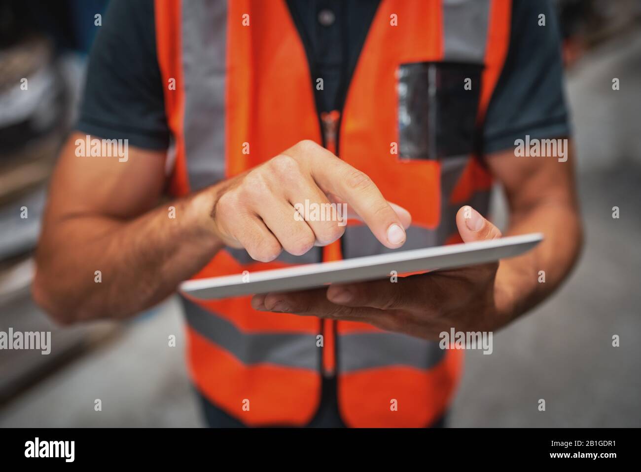 Close-up of man hands using digital tablet computer while standing in the warehouse Stock Photo