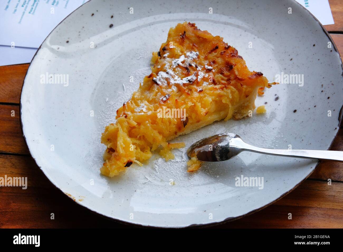 Slice of delicious baked apple open pie on porcelain plate, closeup. Stock Photo