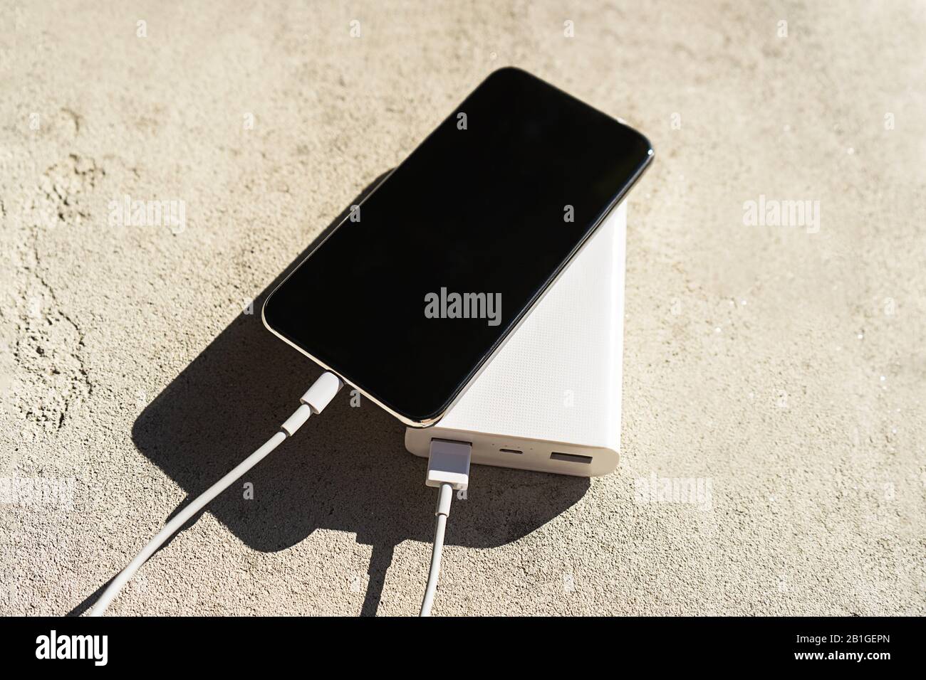 Mobile smart phone charging wirelessly by sharing battery via device