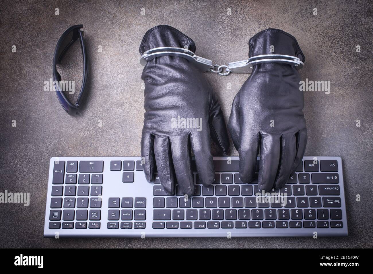 Black gloves in handcuffs Stock Photo