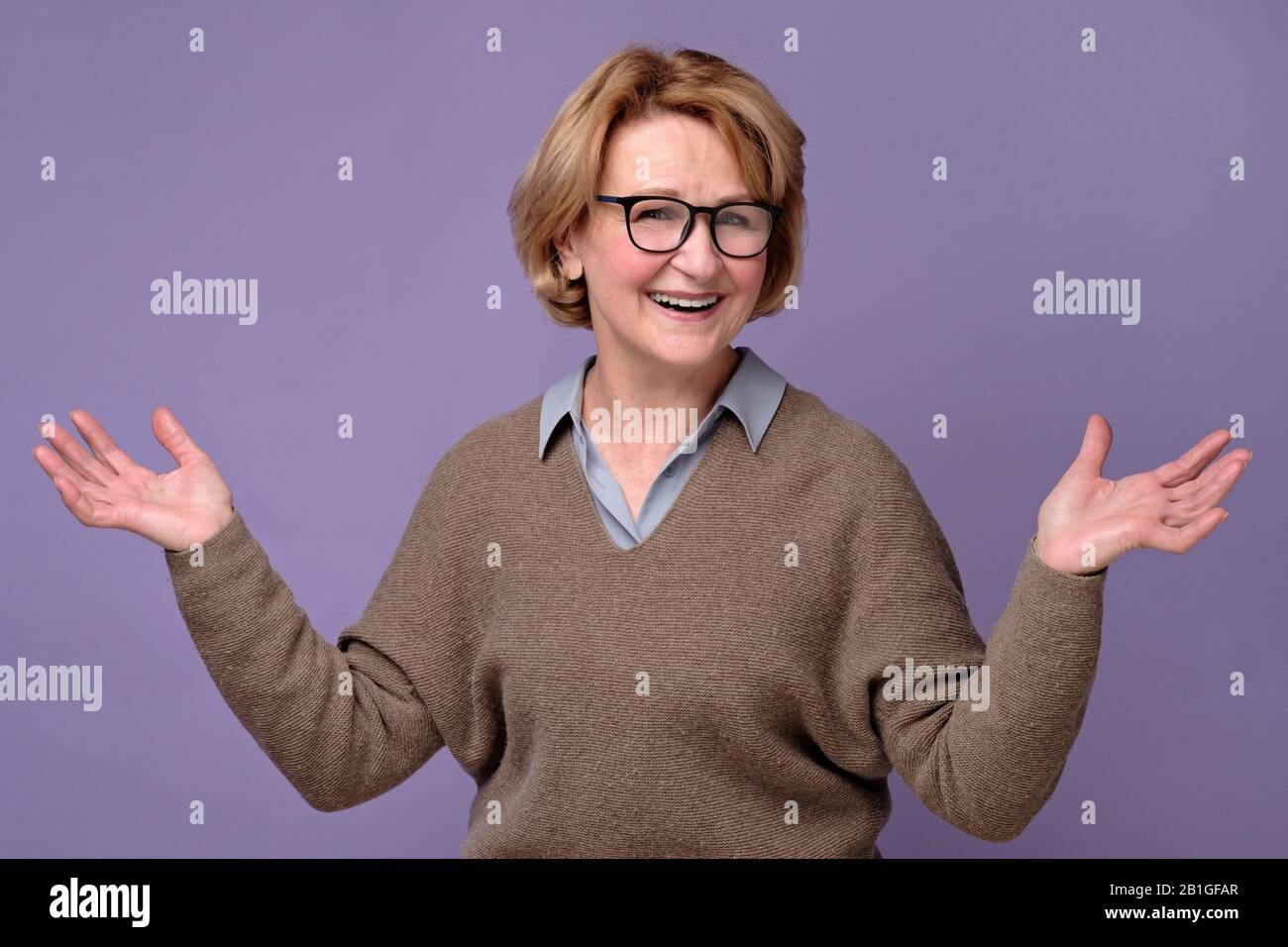 Stylish modern elderly woman. Standing smiling at the camera with