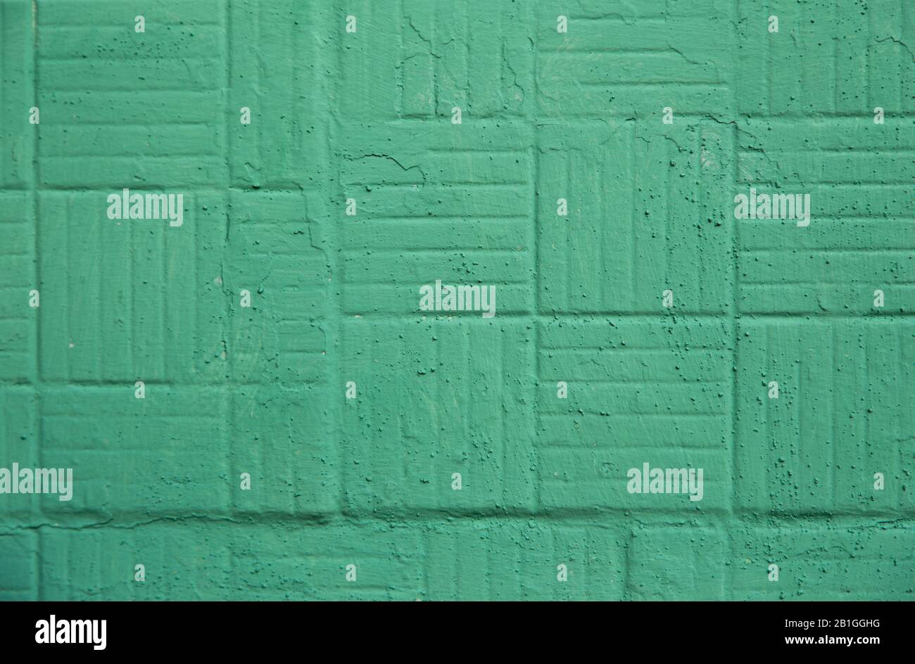 Decorative green painted wall with square and strips background texture. Stock Photo