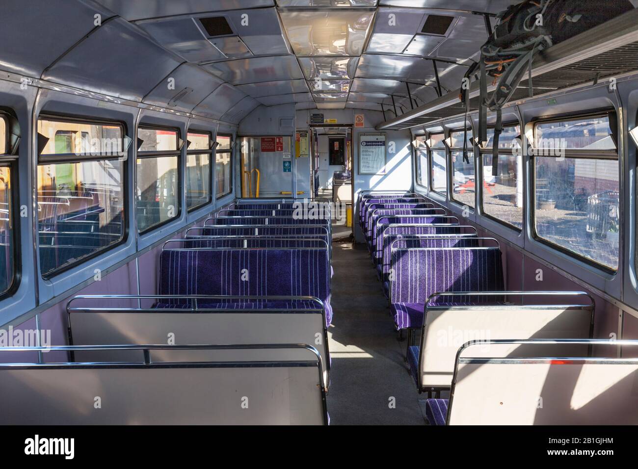 Interior of former Northern rail class 142 pacer train 142060 showing the original bus bench seats on the Wensleydale railway. Stock Photo