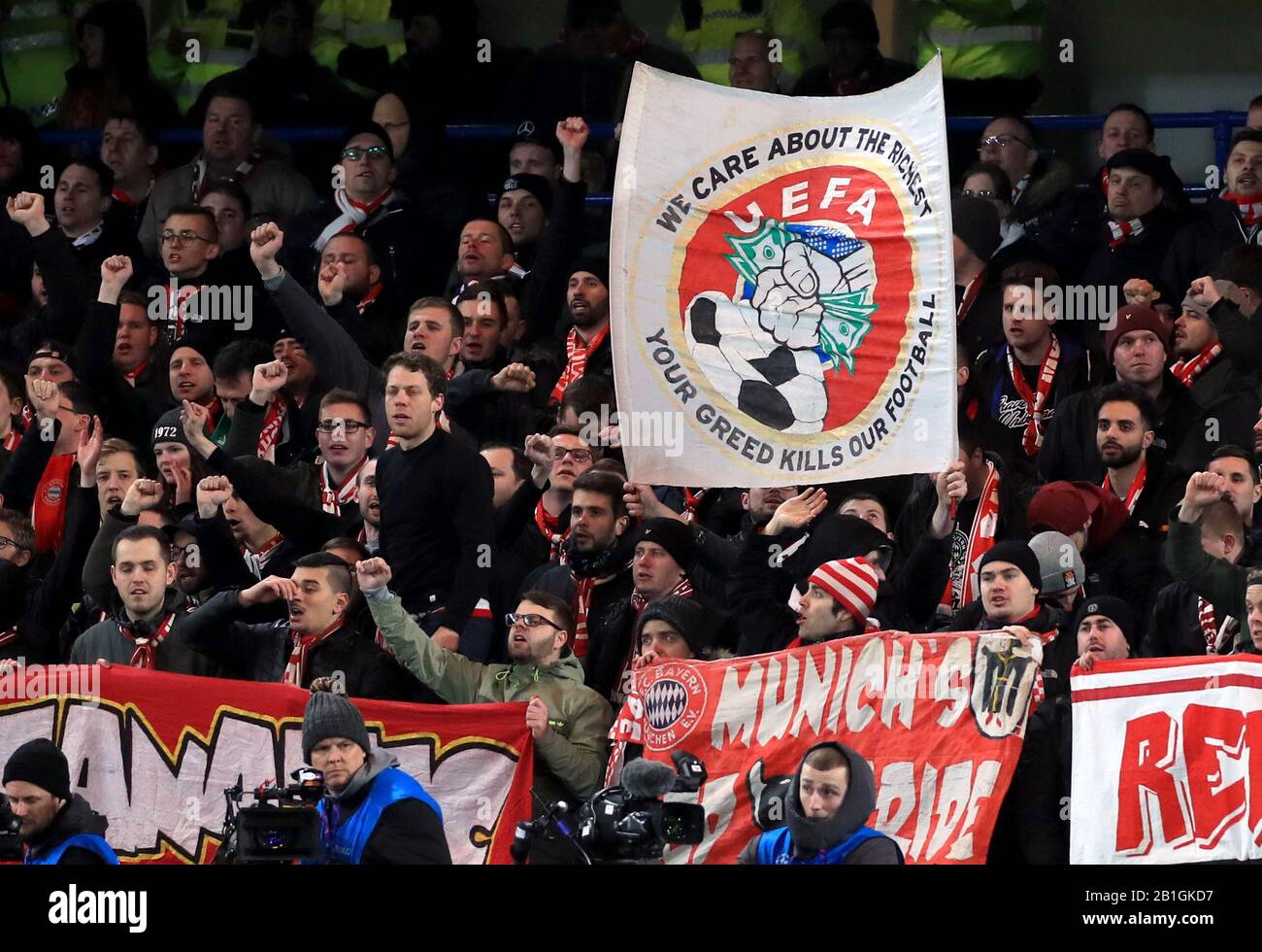 Bayern Munich fans hold a banner protesting against ticket prices in the stands during the UEFA Champions League round of 16 first leg match at Stamford Bridge, London. Stock Photo
