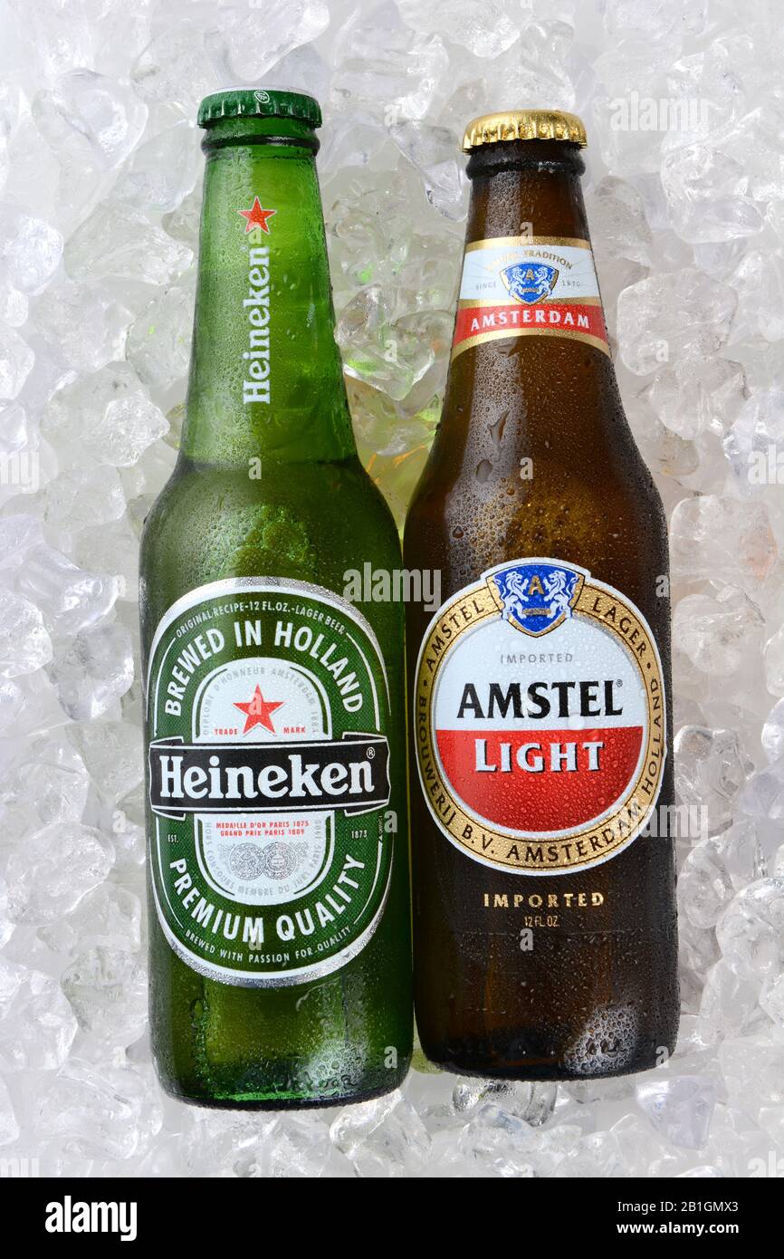 IRVINE, CA - JANUARY 12, 2015: A bottle of Amstel Light and Heineken Beer, full bottles in vertical format. Since 1975, most Heineken beer has been br Stock Photo