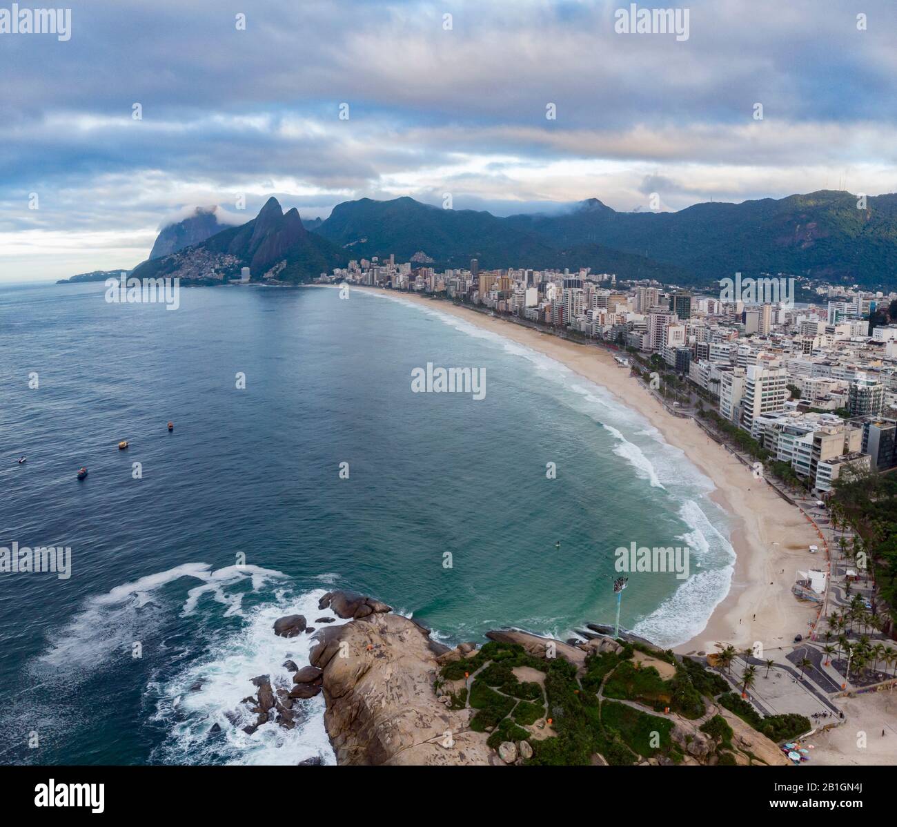 Arpoador rock in Rio de Janeiro with Ipanema beach in the foreground and wider cityscape including Two Brothers mountain in the background Stock Photo
