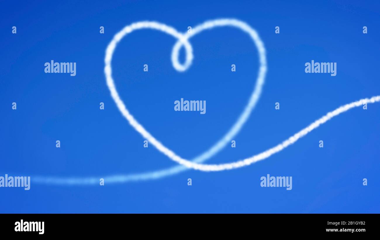 Heart shaped condensation trail against a cloudless blue sky - declaration of love Stock Photo
